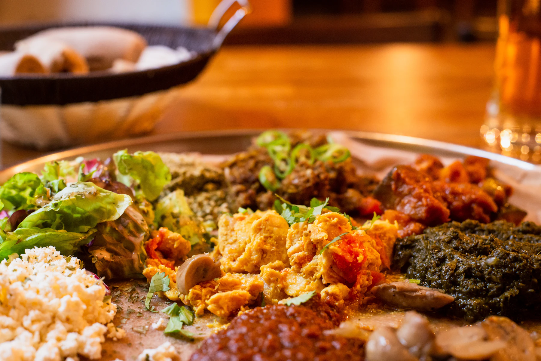 Ethiopian platter with injera, tibs, gomen and ayibe